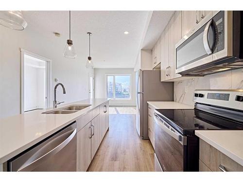 504-71 Shawnee Common Sw, Calgary, AB - Indoor Photo Showing Kitchen With Double Sink