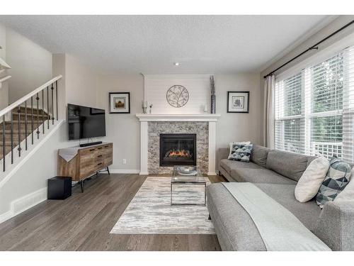 83 Sundown Way, Cochrane, AB - Indoor Photo Showing Living Room With Fireplace