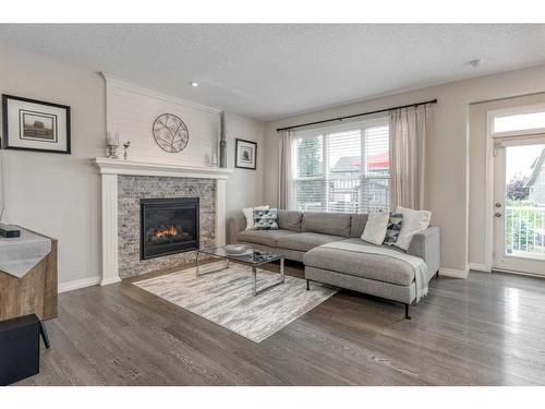 83 Sundown Way, Cochrane, AB - Indoor Photo Showing Living Room With Fireplace