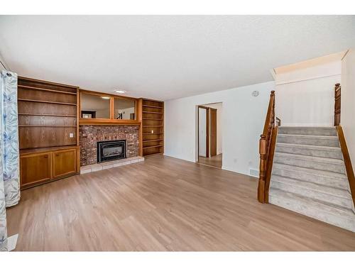 19 Macewan Ridge Close Nw, Calgary, AB - Indoor Photo Showing Living Room With Fireplace