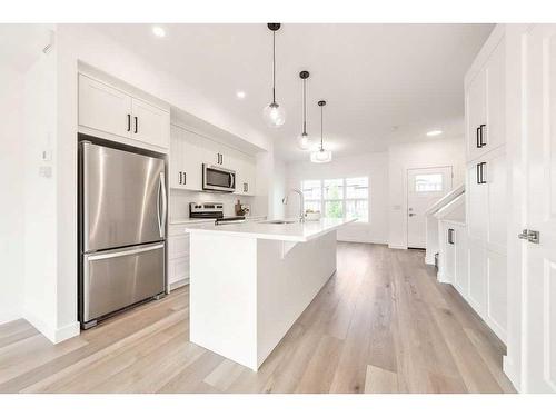 905-525 River Heights Drive, Cochrane, AB - Indoor Photo Showing Kitchen With Stainless Steel Kitchen With Upgraded Kitchen