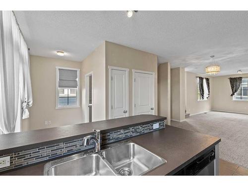 2302-125 Panatella Way Nw, Calgary, AB - Indoor Photo Showing Kitchen With Double Sink