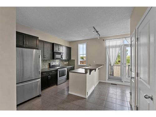 2302-125 Panatella Way Nw, Calgary, AB - Indoor Photo Showing Kitchen With Stainless Steel Kitchen