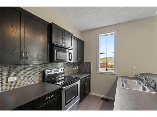 2302-125 Panatella Way Nw, Calgary, AB - Indoor Photo Showing Kitchen With Double Sink