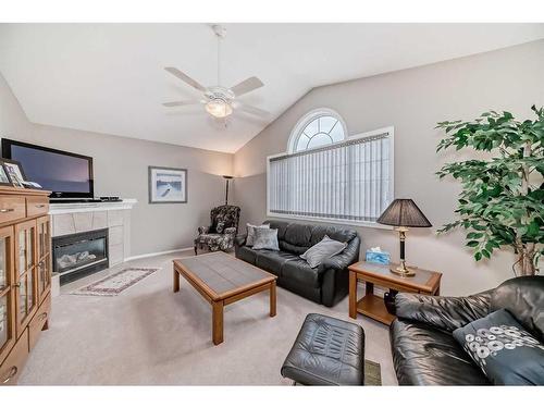 169 Rockbluff Close Nw, Calgary, AB - Indoor Photo Showing Living Room With Fireplace