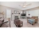 169 Rockbluff Close Nw, Calgary, AB  - Indoor Photo Showing Living Room With Fireplace 