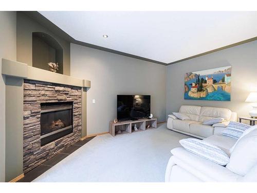 12461 Crestmont Boulevard Sw, Calgary, AB - Indoor Photo Showing Living Room With Fireplace