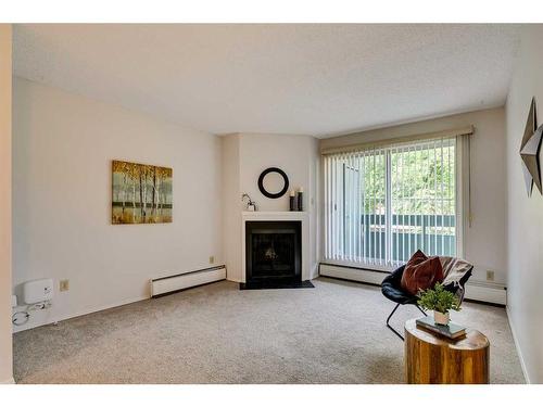 8203-315 Southampton Drive Sw, Calgary, AB - Indoor Photo Showing Living Room With Fireplace