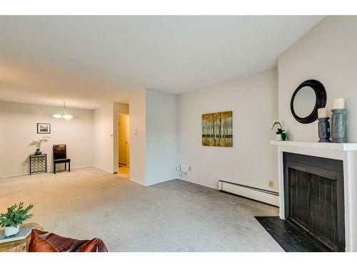 8203-315 Southampton Drive Sw, Calgary, AB - Indoor Photo Showing Living Room With Fireplace