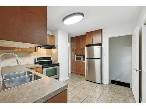 1 Meadowview Road Sw, Calgary, AB - Indoor Photo Showing Kitchen With Stainless Steel Kitchen With Double Sink