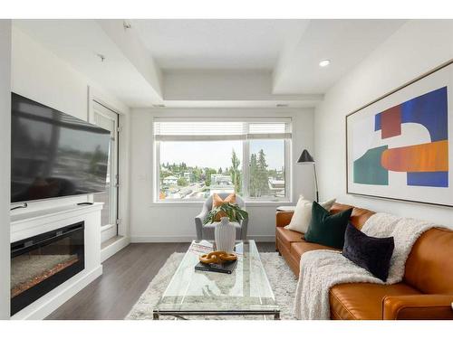 403-3450 19 Street Sw, Calgary, AB - Indoor Photo Showing Living Room With Fireplace