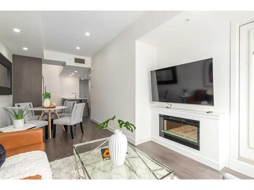 403-3450 19 Street Sw, Calgary, AB - Indoor Photo Showing Living Room With Fireplace