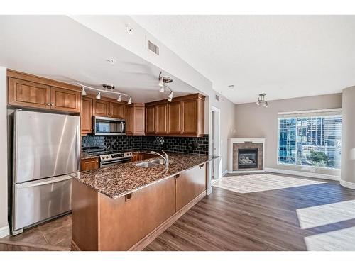 1007-920 5 Avenue Sw, Calgary, AB - Indoor Photo Showing Kitchen With Fireplace With Double Sink