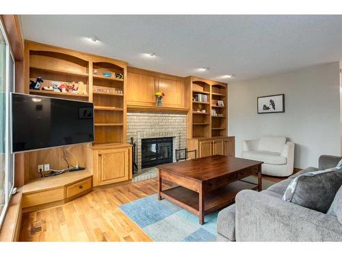 75 Hawkstone Close Nw, Calgary, AB - Indoor Photo Showing Living Room With Fireplace