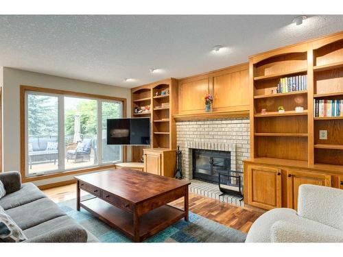 75 Hawkstone Close Nw, Calgary, AB - Indoor Photo Showing Living Room With Fireplace