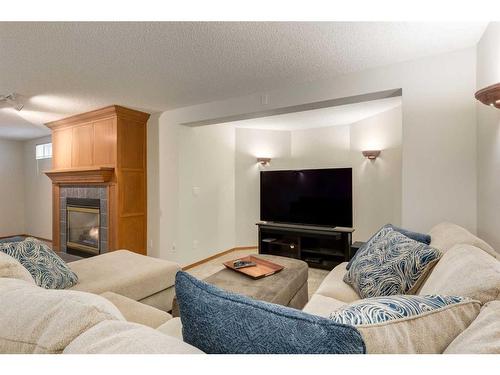 75 Hawkstone Close Nw, Calgary, AB - Indoor Photo Showing Living Room With Fireplace