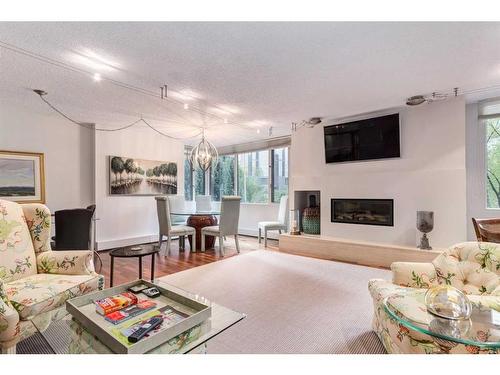 202C-500 Eau Claire Avenue Sw, Calgary, AB - Indoor Photo Showing Living Room With Fireplace