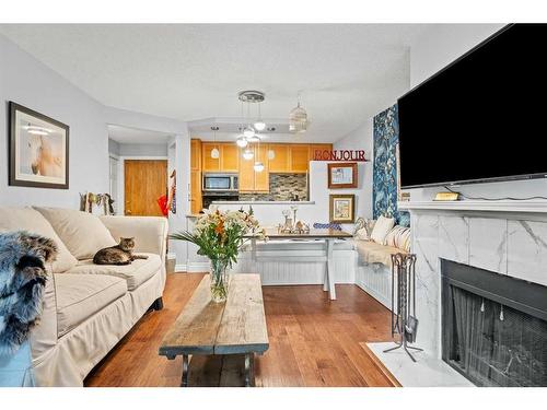 103-1111 13 Avenue Sw, Calgary, AB - Indoor Photo Showing Living Room With Fireplace