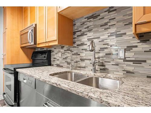 103-1111 13 Avenue Sw, Calgary, AB - Indoor Photo Showing Kitchen With Double Sink With Upgraded Kitchen