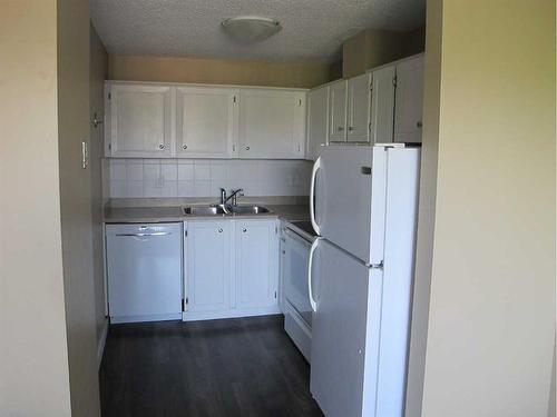 302-280 Banister Drive, Okotoks, AB - Indoor Photo Showing Kitchen With Double Sink