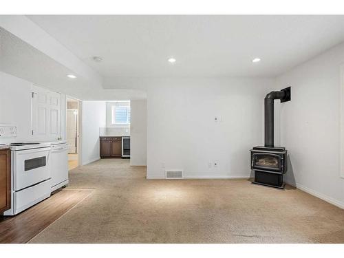 14 Rockyspring Point Nw, Calgary, AB - Indoor Photo Showing Kitchen With Fireplace