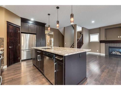 532 Everbrook Way Sw, Calgary, AB - Indoor Photo Showing Kitchen With Fireplace With Stainless Steel Kitchen With Upgraded Kitchen