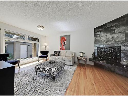 36 Oakbury Place Sw, Calgary, AB - Indoor Photo Showing Living Room With Fireplace