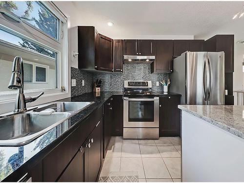 36 Oakbury Place Sw, Calgary, AB - Indoor Photo Showing Kitchen With Double Sink With Upgraded Kitchen