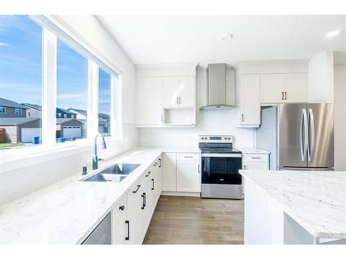 147 Dawson Harbour Hill, Chestermere, AB - Indoor Photo Showing Kitchen With Stainless Steel Kitchen With Double Sink With Upgraded Kitchen