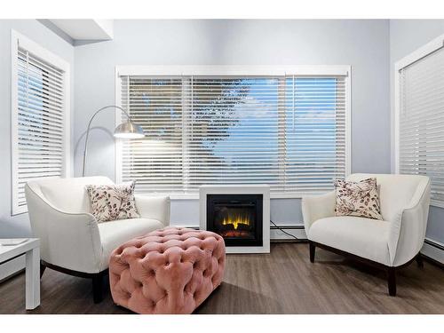 310-4403A 67A Avenue, Olds, AB - Indoor Photo Showing Living Room With Fireplace