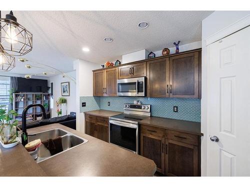 5 Country Village Gate Ne, Calgary, AB - Indoor Photo Showing Kitchen With Stainless Steel Kitchen With Double Sink