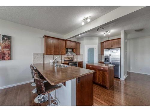 50 Silverado Skies Drive Sw, Calgary, AB - Indoor Photo Showing Kitchen With Double Sink