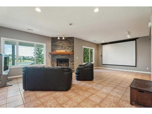 82 Gleneagles Close, Cochrane, AB - Indoor Photo Showing Living Room With Fireplace