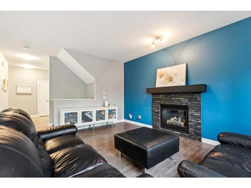 16 Hillcrest Link Sw, Airdrie, AB - Indoor Photo Showing Living Room With Fireplace