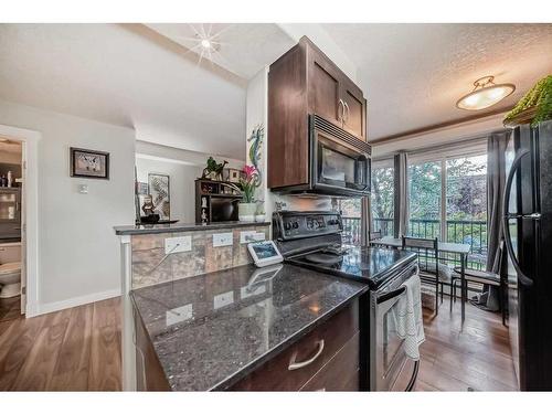 202-1908 11 Avenue Sw, Calgary, AB - Indoor Photo Showing Kitchen With Fireplace