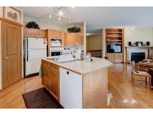 5 Rocky Ridge Gardens Nw, Calgary, AB - Indoor Photo Showing Kitchen With Fireplace