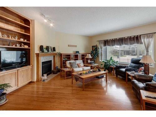 5 Rocky Ridge Gardens Nw, Calgary, AB - Indoor Photo Showing Living Room With Fireplace