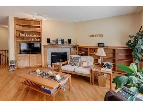 5 Rocky Ridge Gardens Nw, Calgary, AB - Indoor Photo Showing Living Room With Fireplace