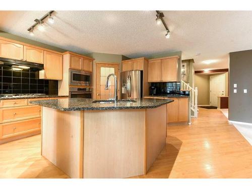 55 Bridlepost Green Sw, Calgary, AB - Indoor Photo Showing Kitchen With Upgraded Kitchen