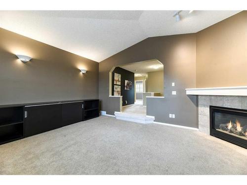 55 Bridlepost Green Sw, Calgary, AB - Indoor With Fireplace