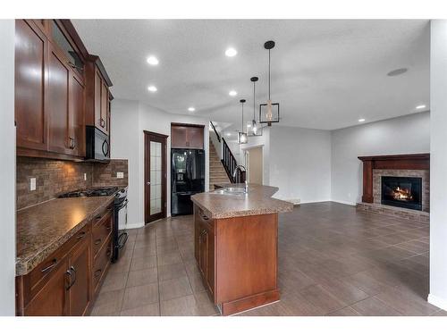 931 Auburn Bay Boulevard Se, Calgary, AB - Indoor Photo Showing Kitchen With Fireplace