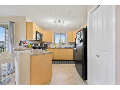 1202-16969 24 Street Sw, Calgary, AB - Indoor Photo Showing Kitchen With Double Sink