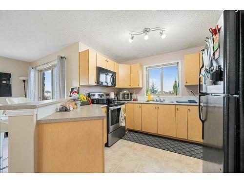 1202-16969 24 Street Sw, Calgary, AB - Indoor Photo Showing Kitchen With Double Sink