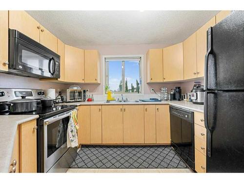 1202-16969 24 Street Sw, Calgary, AB - Indoor Photo Showing Kitchen With Double Sink