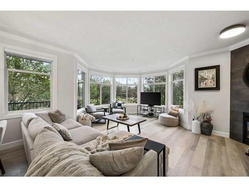 203-59 22 Avenue Sw, Calgary, AB - Indoor Photo Showing Living Room With Fireplace