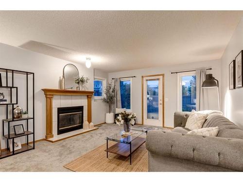 521 Hawkstone Drive Nw, Calgary, AB - Indoor Photo Showing Living Room With Fireplace