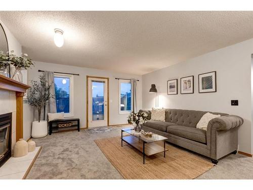 521 Hawkstone Drive Nw, Calgary, AB - Indoor Photo Showing Living Room With Fireplace