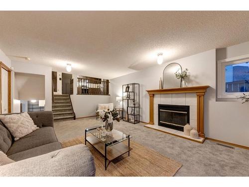 521 Hawkstone Drive Nw, Calgary, AB - Indoor Photo Showing Living Room With Fireplace