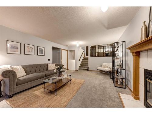 521 Hawkstone Drive Nw, Calgary, AB - Indoor Photo Showing Living Room With Fireplace