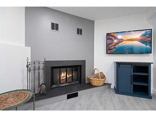 62 Wishart Street, Red Deer, AB - Indoor Photo Showing Living Room With Fireplace